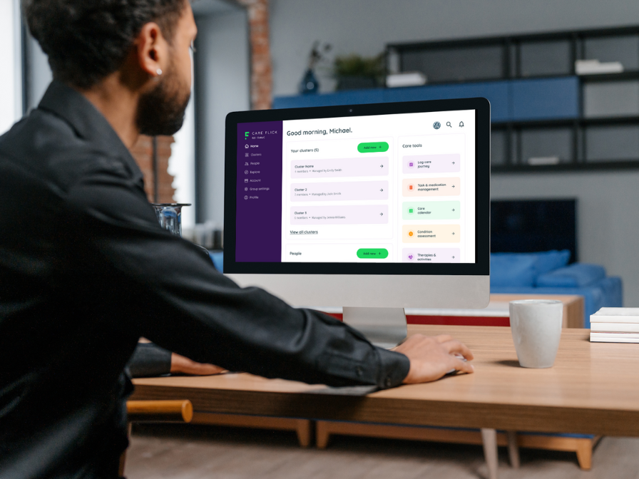 A man sitting at a computer, showing CareFlick Dashboard.