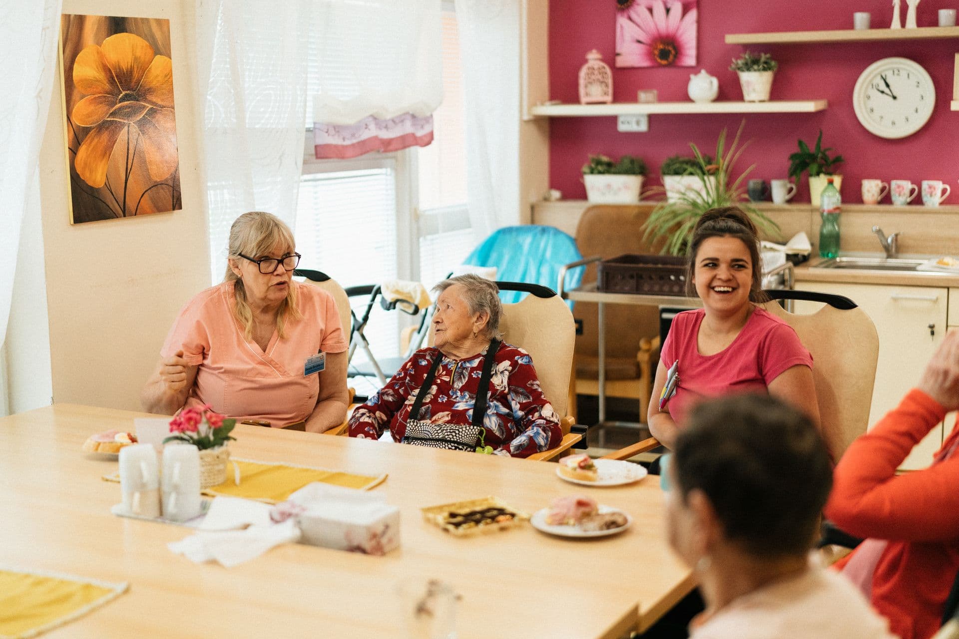 Caregivers and residents sharing time together around a table