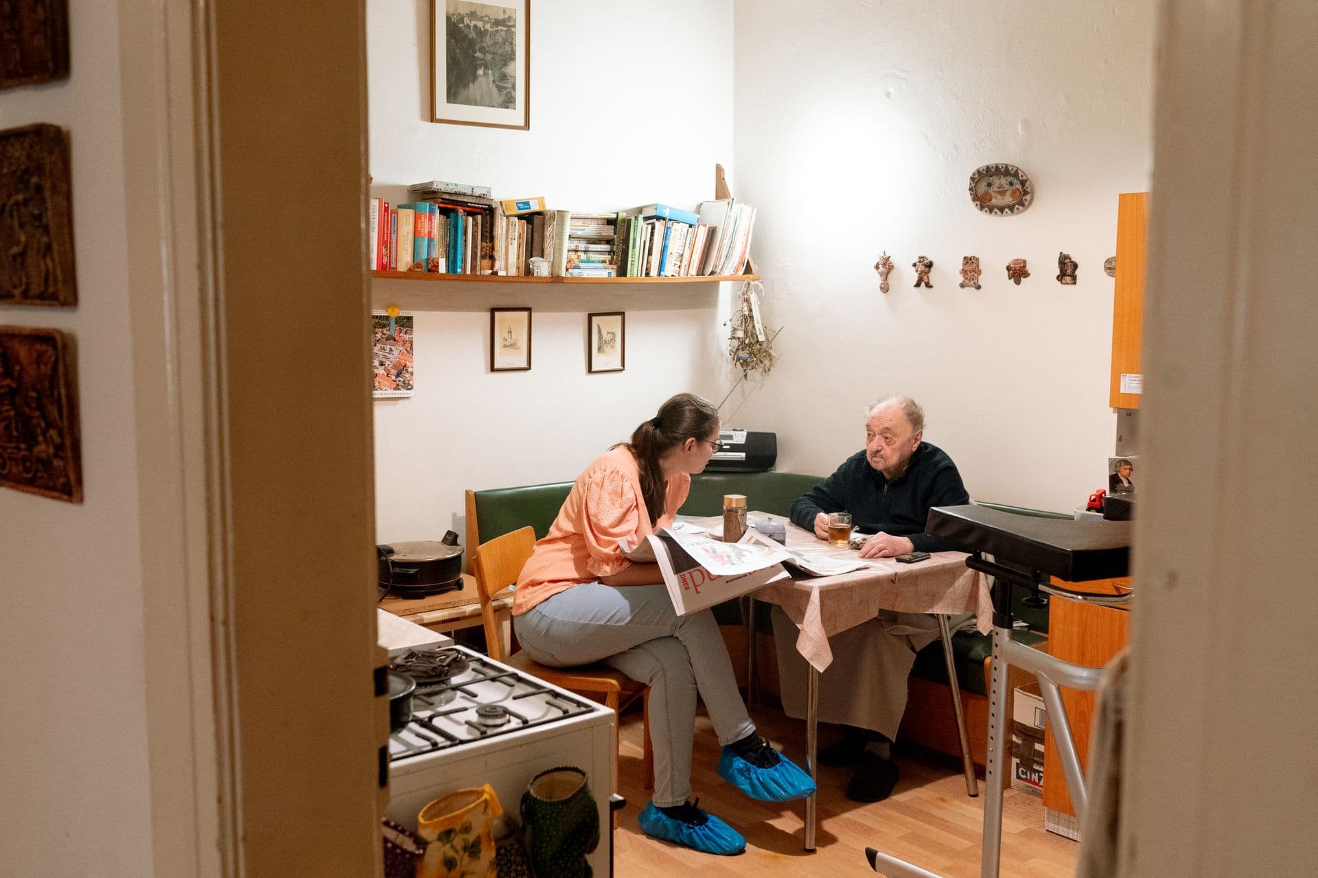 A caregiver speaking with a resident in his home